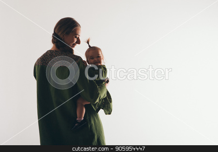 To use this stock image in your creative project, please select the size you need over to the right and click the "Add to Cart" button.
Your downloaded image will come with the Cutcaster watermark removed so don’t worry about the watermark you see on this page. family photo: a woman holding a child in her arms. Fashion for the whole family: mother and daughter dressed in green. Model shows clothes stock photo, family photo: a woman holding a child in her arms. Fashion for the whole family: mother and daughter dressed in green. Model shows clothes by aaalll3110