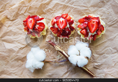 To use this stock image in your creative project, please select the size you need over to the right and click the "Add to Cart" button.
Your downloaded image will come with the Cutcaster watermark removed so don’t worry about the watermark you see on this page. Beautiful cupcakes with strawberries along with a branch of cotton lies on kraft paper stock photo, Beautiful cupcakes with strawberries along with a branch of cotton lies on kraft paper. by Sergiy Artsaba
