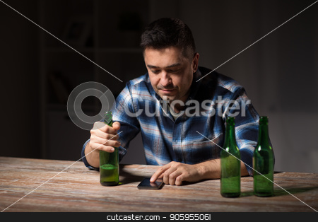 To use this stock image in your creative project, please select the size you need over to the right and click the "Add to Cart" button.
Your downloaded image will come with the Cutcaster watermark removed so don’t worry about the watermark you see on this page. man with smartphone and bottle of beer at night stock photo, alcoholism, alcohol addiction and people concept - drunk man with smartphone and bottle of beer at night by Syda Productions