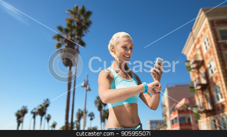 To use this stock image in your creative project, please select the size you need over to the right and click the "Add to Cart" button.
Your downloaded image will come with the Cutcaster watermark removed so don’t worry about the watermark you see on this page. happy woman with fitness tracker and smartphone stock photo, sport, technology and healthy lifestyle concept - smiling young woman with fitness tracker and smartphone exercising over venice beach background in california by Syda Productions