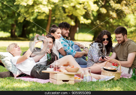 To use this stock image in your creative project, please select the size you need over to the right and click the "Add to Cart" button.
Your downloaded image will come with the Cutcaster watermark removed so don’t worry about the watermark you see on this page. friends with smartphones on picnic at summer park stock photo, friendship, leisure, technology and people concept - group of friends with smartphones chilling on picnic blanket and drinking non alcoholic beer at summer park by Syda Productions