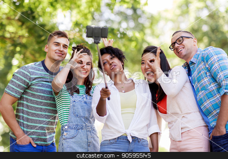 To use this stock image in your creative project, please select the size you need over to the right and click the "Add to Cart" button.
Your downloaded image will come with the Cutcaster watermark removed so don’t worry about the watermark you see on this page. international friends taking selfie in park stock photo, people, friendship and international concept - happy smiling young woman and group of happy friends taking picture by selfie stick in park by Syda Productions