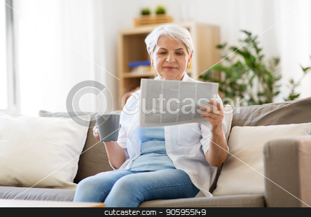 To use this stock image in your creative project, please select the size you need over to the right and click the "Add to Cart" button.
Your downloaded image will come with the Cutcaster watermark removed so don’t worry about the watermark you see on this page. senior woman with coffee reading newspaper at home stock photo, old age, leisure and people concept - happy senior woman drinking coffee or tea and reading newspaper at home by Syda Productions