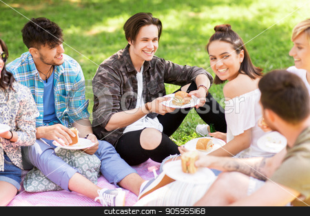 To use this stock image in your creative project, please select the size you need over to the right and click the "Add to Cart" button.
Your downloaded image will come with the Cutcaster watermark removed so don’t worry about the watermark you see on this page. happy friends eating sandwiches at summer picnic stock photo, friendship, leisure and fast food concept - group of happy friends eating sandwiches or burgers at picnic in summer park by Syda Productions