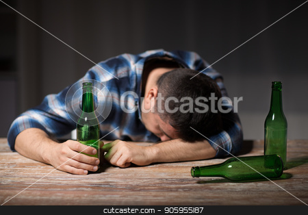 To use this stock image in your creative project, please select the size you need over to the right and click the "Add to Cart" button.
Your downloaded image will come with the Cutcaster watermark removed so don’t worry about the watermark you see on this page. drunk man with beer bottles on table at night stock photo, alcoholism, alcohol addiction and people concept - male alcoholic with beer bottles lying or sleeping on table at night by Syda Productions