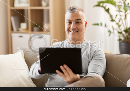 To use this stock image in your creative project, please select the size you need over to the right and click the "Add to Cart" button.
Your downloaded image will come with the Cutcaster watermark removed so don’t worry about the watermark you see on this page. man with tablet pc sitting on sofa at home stock photo, technology, people and lifestyle concept - man with tablet pc computer sitting on sofa at home by Syda Productions