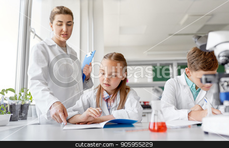 To use this stock image in your creative project, please select the size you need over to the right and click the "Add to Cart" button.
Your downloaded image will come with the Cutcaster watermark removed so don’t worry about the watermark you see on this page. teacher and students studying chemistry at school stock photo, education, science and children concept - teacher and students studying chemistry at school laboratory and writing to workbooks by Syda Productions