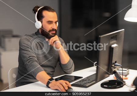 To use this stock image in your creative project, please select the size you need over to the right and click the "Add to Cart" button.
Your downloaded image will come with the Cutcaster watermark removed so don’t worry about the watermark you see on this page. creative man in headphones working at night office stock photo, deadline, technology and people concept - happy creative man with headphones and computer listening to music and working at night office by Syda Productions