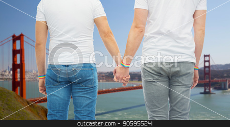 To use this stock image in your creative project, please select the size you need over to the right and click the "Add to Cart" button.
Your downloaded image will come with the Cutcaster watermark removed so don’t worry about the watermark you see on this page. male couple with gay pride rainbow wristbands stock photo, lgbt, same-sex relationships and homosexual concept - close up of male couple wearing gay pride rainbow awareness wristbands holding hands over golden gate bridge in san francisco bay background by Syda Productions