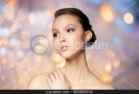 To use this stock image in your creative project, please select the size you need over to the right and click the "Add to Cart" button.
Your downloaded image will come with the Cutcaster watermark removed so don’t worry about the watermark you see on this page. close up of beautiful woman face with earring stock photo, beauty, jewelry, accessories, people and luxury concept - close up of beautiful asian woman face with earring over holidays lights background by Syda Productions