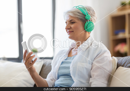 To use this stock image in your creative project, please select the size you need over to the right and click the "Add to Cart" button.
Your downloaded image will come with the Cutcaster watermark removed so don’t worry about the watermark you see on this page. senior woman in headphones listening to music stock photo, technology, people and lifestyle concept - happy senior woman in headphones and smartphone listening to music at home by Syda Productions