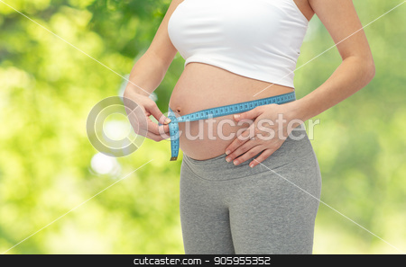 To use this stock image in your creative project, please select the size you need over to the right and click the "Add to Cart" button.
Your downloaded image will come with the Cutcaster watermark removed so don’t worry about the watermark you see on this page. pregnant woman measuring belly by tape measure stock photo, pregnancy, people and expectation concept - close up of pregnant woman measuring belly by tape measure over green natural background by Syda Productions