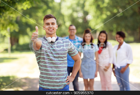 To use this stock image in your creative project, please select the size you need over to the right and click the "Add to Cart" button.
Your downloaded image will come with the Cutcaster watermark removed so don’t worry about the watermark you see on this page. group of happy international friends outdoors stock photo, people, friendship and international concept - happy smiling man with headphones showing thumbs up and group of happy friends outdoors by Syda Productions
