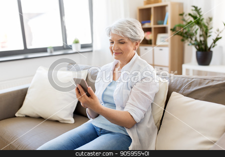 To use this stock image in your creative project, please select the size you need over to the right and click the "Add to Cart" button.
Your downloaded image will come with the Cutcaster watermark removed so don’t worry about the watermark you see on this page. happy senior woman with smartphone at home stock photo, technology, communication and people concept - happy senior woman with smartphone at home by Syda Productions