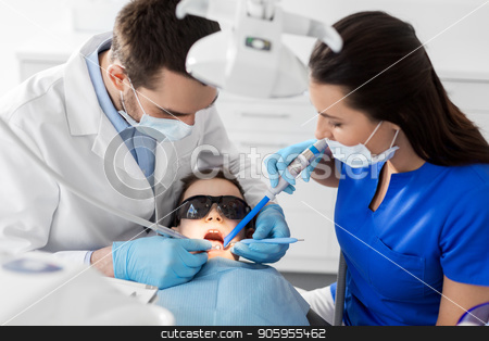 To use this stock image in your creative project, please select the size you need over to the right and click the "Add to Cart" button.
Your downloaded image will come with the Cutcaster watermark removed so don’t worry about the watermark you see on this page. dentist treating kid teeth at dental clinic stock photo, medicine, dentistry and healthcare concept - dentist and assistant with dental drill and saliva ejector treating kid patient teeth at dental clinic by Syda Productions