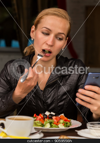 To use this stock image in your creative project, please select the size you need over to the right and click the "Add to Cart" button.
Your downloaded image will come with the Cutcaster watermark removed so don’t worry about the watermark you see on this page. businesswoman eating salad in an outdoor cafe. Healthy lifestyle: girl eating green tasty food and checks email on your phone stock photo, businesswoman eating salad in an outdoor cafe. Healthy lifestyle: girl eating green tasty food by Alexander