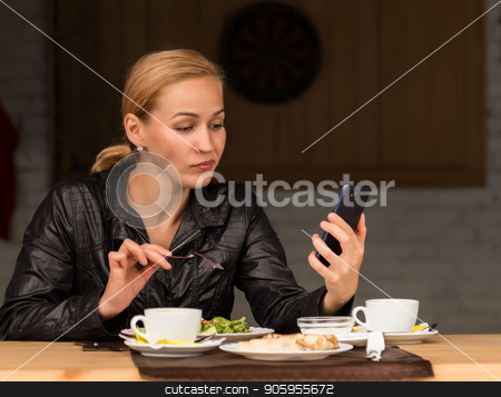 To use this stock image in your creative project, please select the size you need over to the right and click the "Add to Cart" button.
Your downloaded image will come with the Cutcaster watermark removed so don’t worry about the watermark you see on this page. lunch in an outdoor cafe. businesswoman eating salad and checks email on your phone stock photo, businesswoman eating salad in an outdoor cafe. Healthy lifestyle: girl eating green tasty food by Alexander