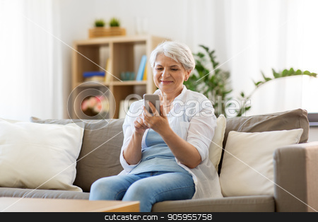 To use this stock image in your creative project, please select the size you need over to the right and click the "Add to Cart" button.
Your downloaded image will come with the Cutcaster watermark removed so don’t worry about the watermark you see on this page. happy senior woman with smartphone at home stock photo, technology, communication and people concept - happy senior woman with smartphone at home by Syda Productions