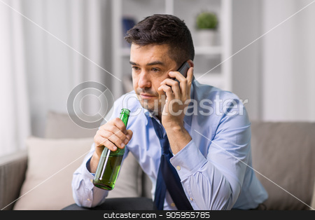 To use this stock image in your creative project, please select the size you need over to the right and click the "Add to Cart" button.
Your downloaded image will come with the Cutcaster watermark removed so don’t worry about the watermark you see on this page. man drinking alcohol and calling on smartphone stock photo, alcoholism, alcohol addiction and people concept - male alcoholic drinking beer and calling on smartphone at home by Syda Productions