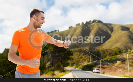 To use this stock image in your creative project, please select the size you need over to the right and click the "Add to Cart" button.
Your downloaded image will come with the Cutcaster watermark removed so don’t worry about the watermark you see on this page. man with smart watch or fitness tracker stock photo, sport, technology and healthy lifestyle concept - smiling young man with smart watch or fitness tracker over big sur hills and road background in california by Syda Productions
