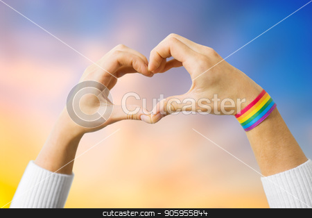 To use this stock image in your creative project, please select the size you need over to the right and click the "Add to Cart" button.
Your downloaded image will come with the Cutcaster watermark removed so don’t worry about the watermark you see on this page. woman with gay awareness wristband showing heart stock photo, homosexual and lgbt concept - close up of woman wearing gay pride awareness ribbon wristband showing hand heart over evening sky background by Syda Productions