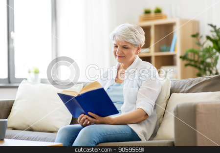 To use this stock image in your creative project, please select the size you need over to the right and click the "Add to Cart" button.
Your downloaded image will come with the Cutcaster watermark removed so don’t worry about the watermark you see on this page. happy smiling senior woman reading book at home stock photo, age, leisure and people concept - happy smiling senior woman reading book at home by Syda Productions