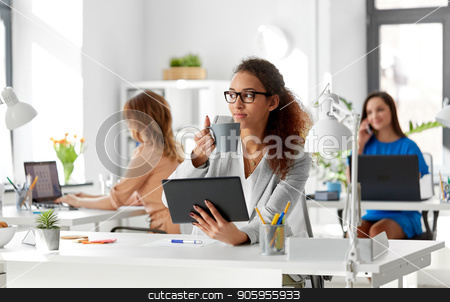 To use this stock image in your creative project, please select the size you need over to the right and click the "Add to Cart" button.
Your downloaded image will come with the Cutcaster watermark removed so don’t worry about the watermark you see on this page. businesswoman with tablet pc and coffee at office stock photo, business, technology and people concept - african american businesswoman with tablet pc computer drinking coffee at office by Syda Productions