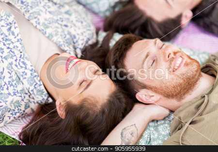 To use this stock image in your creative project, please select the size you need over to the right and click the "Add to Cart" button.
Your downloaded image will come with the Cutcaster watermark removed so don’t worry about the watermark you see on this page. happy friends chilling on picnic blanket at summer stock photo, friendship, leisure and summer concept - group of happy friends chilling on picnic blanket at park by Syda Productions