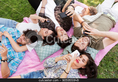 To use this stock image in your creative project, please select the size you need over to the right and click the "Add to Cart" button.
Your downloaded image will come with the Cutcaster watermark removed so don’t worry about the watermark you see on this page. friends with smartphones on picnic blanket stock photo, friendship, leisure, technology and people concept - group of friends with smartphones chilling on picnic blanket at summer park by Syda Productions