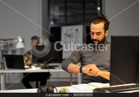 To use this stock image in your creative project, please select the size you need over to the right and click the "Add to Cart" button.
Your downloaded image will come with the Cutcaster watermark removed so don’t worry about the watermark you see on this page. creative man with smartwatch at night office stock photo, deadline, technology and people concept - creative man with smartwatch and computer working late at night office by Syda Productions