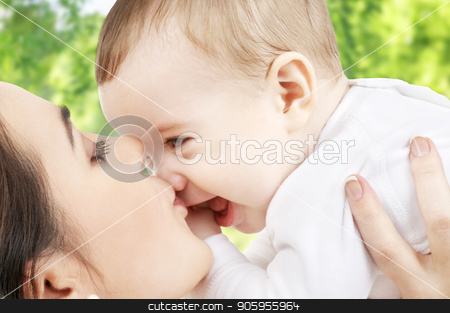 To use this stock image in your creative project, please select the size you need over to the right and click the "Add to Cart" button.
Your downloaded image will come with the Cutcaster watermark removed so don’t worry about the watermark you see on this page. mother kissing baby over green natural background stock photo, family and motherhood concept - happy smiling young mother kissing little baby over green natural background by Syda Productions