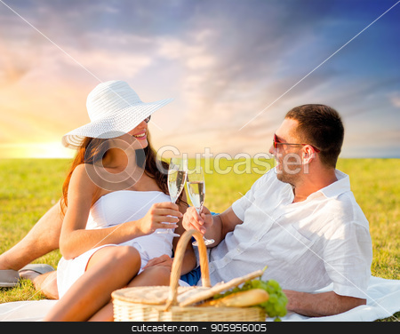 To use this stock image in your creative project, please select the size you need over to the right and click the "Add to Cart" button.
Your downloaded image will come with the Cutcaster watermark removed so don’t worry about the watermark you see on this page. smiling couple drinking champagne at picnic stock photo, love, dating, people and celebration concept - smiling couple drinking champagne at picnic on meadow over sunset sky background by Syda Productions