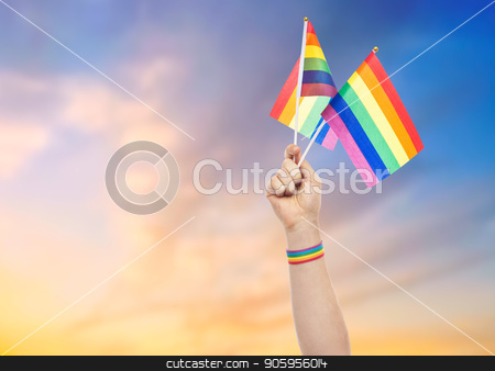 To use this stock image in your creative project, please select the size you need over to the right and click the "Add to Cart" button.
Your downloaded image will come with the Cutcaster watermark removed so don’t worry about the watermark you see on this page. hand with gay pride rainbow flags and wristband stock photo, lgbt, same-sex relationships and homosexual concept - close up of male hand with gay pride awareness wristband holding rainbow flags over evening sky background by Syda Productions