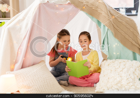 To use this stock image in your creative project, please select the size you need over to the right and click the "Add to Cart" button.
Your downloaded image will come with the Cutcaster watermark removed so don’t worry about the watermark you see on this page. little girls reading book in kids tent at home stock photo, childhood, friendship and hygge concept - happy little girls reading book with torch light in kids tent or teepee at home by Syda Productions
