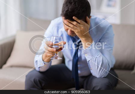 To use this stock image in your creative project, please select the size you need over to the right and click the "Add to Cart" button.
Your downloaded image will come with the Cutcaster watermark removed so don’t worry about the watermark you see on this page. drunk man with glass of alcohol at home stock photo, alcoholism, alcohol addiction and people concept - male alcoholic drinking brandy at home by Syda Productions