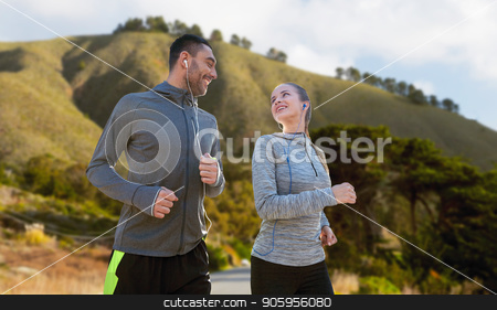 To use this stock image in your creative project, please select the size you need over to the right and click the "Add to Cart" button.
Your downloaded image will come with the Cutcaster watermark removed so don’t worry about the watermark you see on this page. couple with earphones running over big sur stock photo, fitness, sport and technology concept - happy couple running and listening to music in earphones over big sur hills background in california by Syda Productions