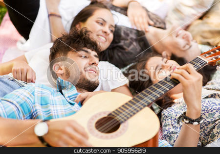 To use this stock image in your creative project, please select the size you need over to the right and click the "Add to Cart" button.
Your downloaded image will come with the Cutcaster watermark removed so don’t worry about the watermark you see on this page. friends playing guitar and chilling on blanket stock photo, friendship, leisure and summer concept - group of happy smiling friends playing guitar and chilling on picnic blanket by Syda Productions