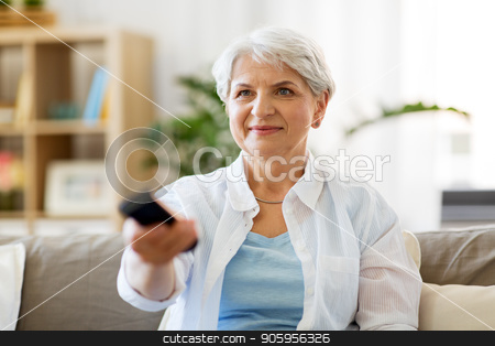 To use this stock image in your creative project, please select the size you need over to the right and click the "Add to Cart" button.
Your downloaded image will come with the Cutcaster watermark removed so don’t worry about the watermark you see on this page. senior woman with remote watching tv at home stock photo, people, television and entertainment concept - senior woman in eyeglasses with remote control watching tv at home by Syda Productions