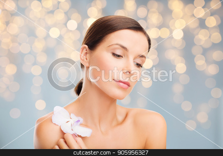 To use this stock image in your creative project, please select the size you need over to the right and click the "Add to Cart" button.
Your downloaded image will come with the Cutcaster watermark removed so don’t worry about the watermark you see on this page. woman with orchid flower over green background stock photo, wellness and beauty concept - beautiful bare woman with orchid flower over holidays lights background by Syda Productions