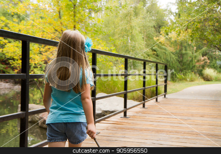 To use this stock image in your creative project, please select the size you need over to the right and click the "Add to Cart" button.
Your downloaded image will come with the Cutcaster watermark removed so don’t worry about the watermark you see on this page. Walking down a path stock photo, Little girl on a wooden bridge in the woods walking down her path of exploration by txking