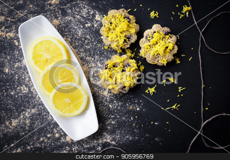 To use this stock image in your creative project, please select the size you need over to the right and click the "Add to Cart" button.
Your downloaded image will come with the Cutcaster watermark removed so don’t worry about the watermark you see on this page. lemon cupcakes on a black background stock photo, lemon cupcakes on a black background and a lemon on a plate by Sergiy Artsaba