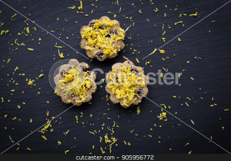 To use this stock image in your creative project, please select the size you need over to the right and click the "Add to Cart" button.
Your downloaded image will come with the Cutcaster watermark removed so don’t worry about the watermark you see on this page. lemon cupcakes on a black background stock photo, Three lemon cupcakes on a black background by Sergiy Artsaba