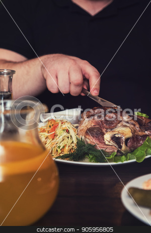 To use this stock image in your creative project, please select the size you need over to the right and click the "Add to Cart" button.
Your downloaded image will come with the Cutcaster watermark removed so don’t worry about the watermark you see on this page. Man eats tasty dish of pork shank stock photo, Man eats tasty dish of pork shank, closeup photo by olinchuk