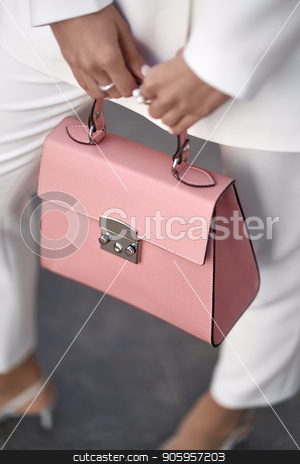 To use this stock image in your creative project, please select the size you need over to the right and click the "Add to Cart" button.
Your downloaded image will come with the Cutcaster watermark removed so don’t worry about the watermark you see on this page. Model with bag outdoors stock photo, Nice girl is posing with a coral bag on the wall background outdoors. She wears a white pantsuit with light shoes. Closeup vertical photo. by bezikus