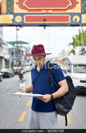 To use this stock image in your creative project, please select the size you need over to the right and click the "Add to Cart" button.
Your downloaded image will come with the Cutcaster watermark removed so don’t worry about the watermark you see on this page. Traveler on city street stock photo, Thoughtful tourist with a map in the hands stands on the city street. He wears a blue polo, gray shorts, crimson hat, black backpack and holds also a drink. Outdoors. Vertical. by bezikus