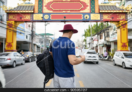To use this stock image in your creative project, please select the size you need over to the right and click the "Add to Cart" button.
Your downloaded image will come with the Cutcaster watermark removed so don’t worry about the watermark you see on this page. Traveler on city street stock photo, Young tourist with a map in the hands stands on the city street. He wears a blue polo, gray shorts, crimson hat, black backpack and holds also a drink. Outdoors. Shoot from the back. Horizontal. by bezikus