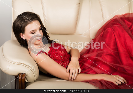To use this stock image in your creative project, please select the size you need over to the right and click the "Add to Cart" button.
Your downloaded image will come with the Cutcaster watermark removed so don’t worry about the watermark you see on this page. young elegant woman with professional hairstyle in long red dress rested on sofa stock photo, young elegant woman with professional hairstyle in long red dress rested on sofa. by Alexander