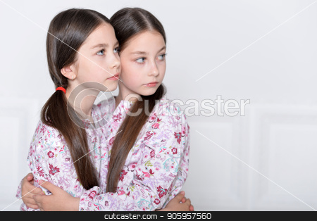 To use this stock image in your creative project, please select the size you need over to the right and click the "Add to Cart" button.
Your downloaded image will come with the Cutcaster watermark removed so don’t worry about the watermark you see on this page. cute little girls posing stock photo, Studio portrait of cute twin sisters posing by Ruslan Huzau