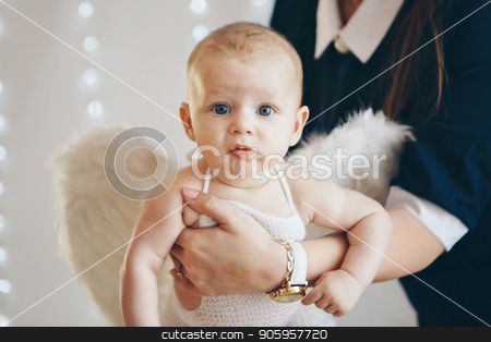 To use this stock image in your creative project, please select the size you need over to the right and click the "Add to Cart" button.
Your downloaded image will come with the Cutcaster watermark removed so don’t worry about the watermark you see on this page. a small child with wings of an angel lying on women's hands. stock photo, a small child with wings of an angel lying on women's hands. by aaalll3110