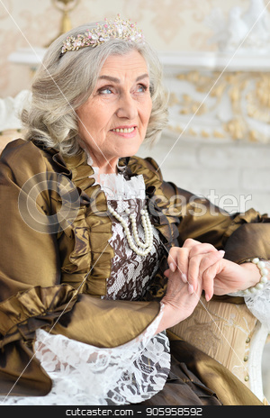 To use this stock image in your creative project, please select the size you need over to the right and click the "Add to Cart" button.
Your downloaded image will come with the Cutcaster watermark removed so don’t worry about the watermark you see on this page. senior woman sitting in vintage chair stock photo, Beautiful senior woman in dress sitting in vintage chair near fireplace by Ruslan Huzau